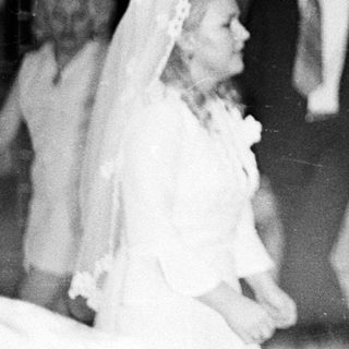 Couple dancing at a wedding reception, black and white photo.