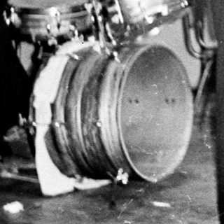 Black and white photo of a band performing indoors.