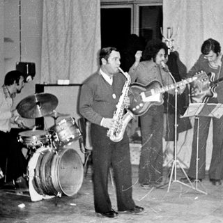 Band performing on stage, likely in the 1970s.