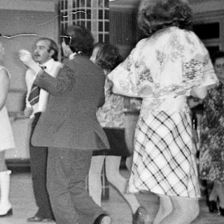 Black and white photo of a wedding reception dance.