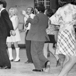 Black and white photo of a wedding reception dance.