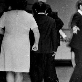 Couple dances at a wedding reception in the 1970s.
