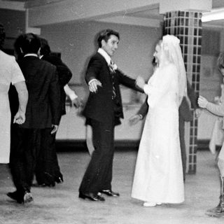 Couple dances at a wedding reception in the 1970s.