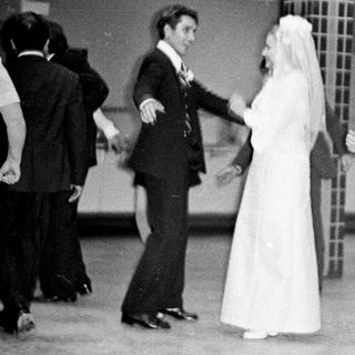 Couple dances at a wedding reception in the 1970s.