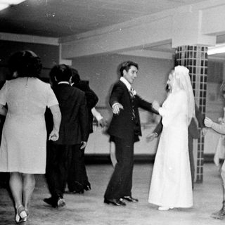 Couple dances at a wedding reception in the 1970s.