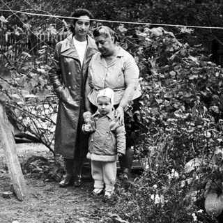 Black and white photo of a woman and child outdoors.