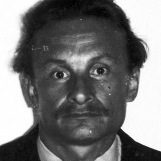 Black and white portrait of a man in a suit.