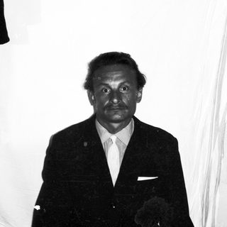 Black and white portrait of a man in a suit.