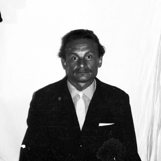 Black and white portrait of a man in a suit.