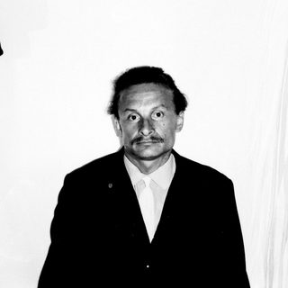 Black and white portrait of a man in a suit.