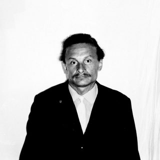 Black and white portrait of a man in a suit.