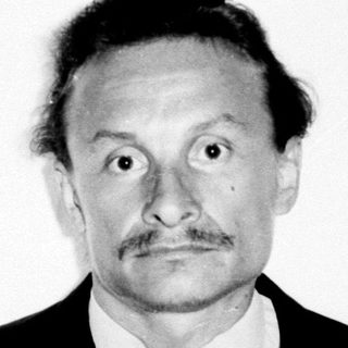 Black and white portrait of a man in a suit.