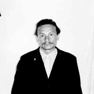 Black and white portrait of a man in a suit.