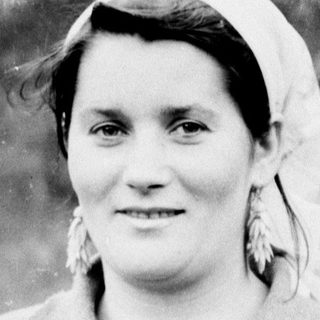 Black and white portrait of a woman wearing a headscarf.