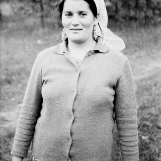 Black and white portrait of a woman wearing a headscarf.