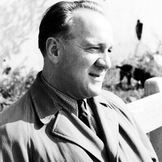 Man in a coat looking off to the side.