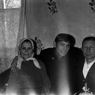 Black and white photo of a family standing together.