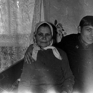 Black and white photo of a family standing together.