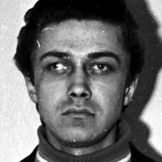 Black and white portrait of a man in a suit.