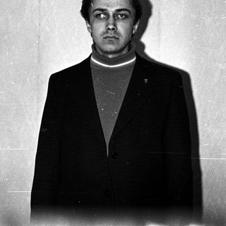 Black and white portrait of a man in a suit.