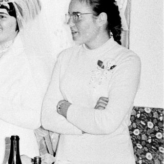 Black and white photo of a wedding reception gathering.