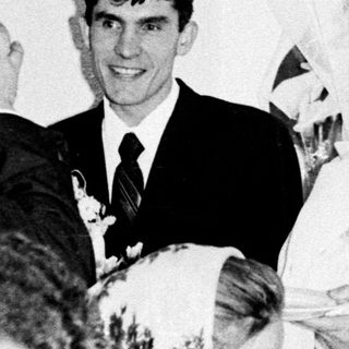 Black and white photo of a wedding reception gathering.