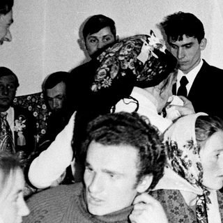 Black and white photo of a wedding celebration gathering.