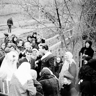 Black and white photo of a wedding gathering outdoors.