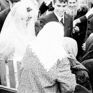 Black and white photo of a wedding gathering outdoors.