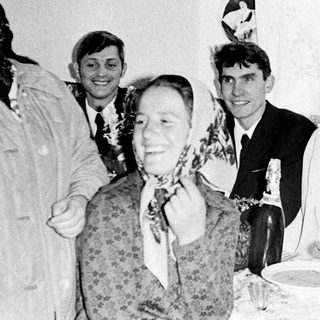 Group gathered at a table, possibly celebrating a wedding.