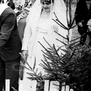 Black and white wedding ceremony taking place outdoors.