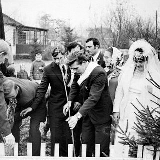 Black and white wedding ceremony taking place outdoors.