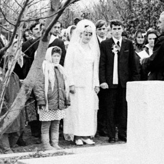 Group gathers for a ceremony near a monument.