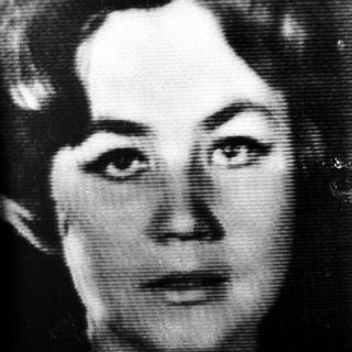 Black and white portrait of a woman with wavy hair.