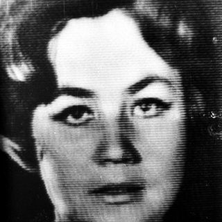 Black and white portrait of a woman with wavy hair.