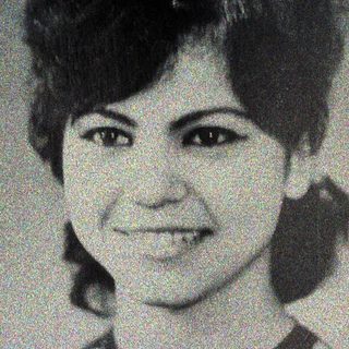 Black and white portrait of a woman with short hair.
