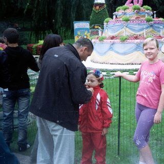 People view a large floral display with a young girl.