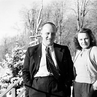 Couple standing outdoors in a snowy, winter landscape.