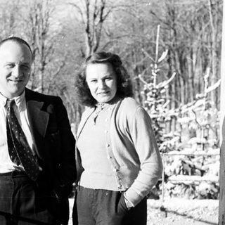 Couple standing outdoors in a snowy, winter landscape.