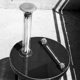 Lab equipment sits on a table in a room.
