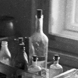 Vintage laboratory equipment on a table near a window.