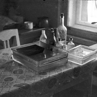 Vintage laboratory equipment on a table near a window.