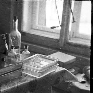 Vintage laboratory equipment on a table near a window.