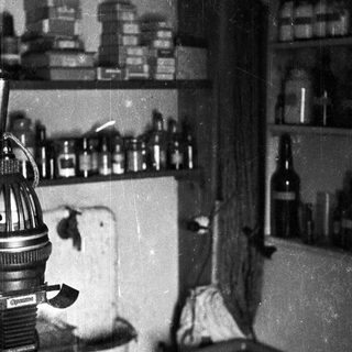 Vintage laboratory with equipment, glassware, and shelving.