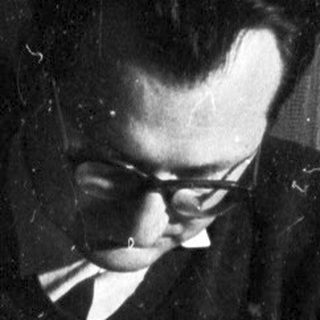 Baby and man seated, engaged in a moment together.