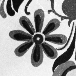 Black and white floral design, possibly folk art.