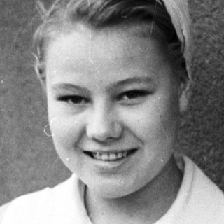 Young woman in a nurse's uniform smiles for a portrait.