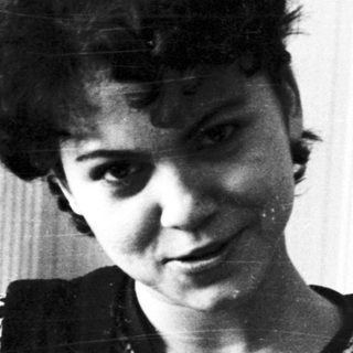Black and white portrait of a young woman with short hair.