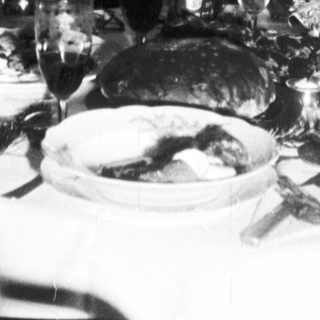 Family gathered around a table, decorated for Christmas.