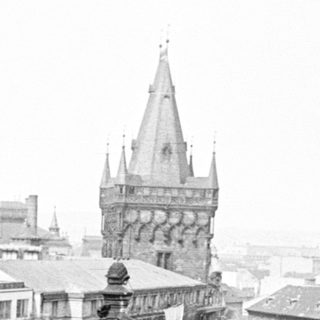Overhead view of a cityscape with a prominent spire.